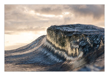 Load image into Gallery viewer, Persephon – thick heavy wave with a flat mesa-like top, reflective lines of golden sunrise light streaking down the face, warm amber light breaking through dramatic clouds, glassy ocean, South Coast, Sapphire Coast, coastal decor photography by Greg Selby