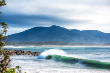 Load image into Gallery viewer, Breaking ocean wave at Horseshoe Bay, Bermagui with Gulaga in the background on the Sapphire Coast of New South Wales by Greg Selby.