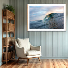 Load image into Gallery viewer, Living room with a beige armchair, wicker bookshelf, and framed artwork of a wave by artist Greg Selby 