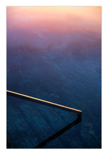 Load image into Gallery viewer, Lull fine art photograph of Bermagui Blue Pool featuring pastel sunrise reflections over deep blue ocean water and a minimalist pool edge in New South Wales, Australia.
