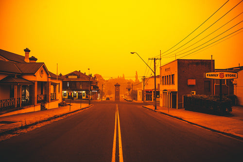 The CLock tower in bega and the town glowing  orange