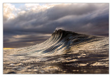 Load image into Gallery viewer, Larune A beautiful unbroken wave first light Larune – golden hour wave photography, unbroken swell with moody clouds, warm golden light on dark water, Australian coastline, fine art print by Greg Selby Sapphire coast